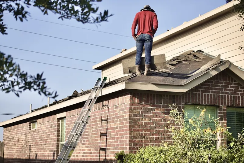 Professional roofer working on a residential roof in Webatuck